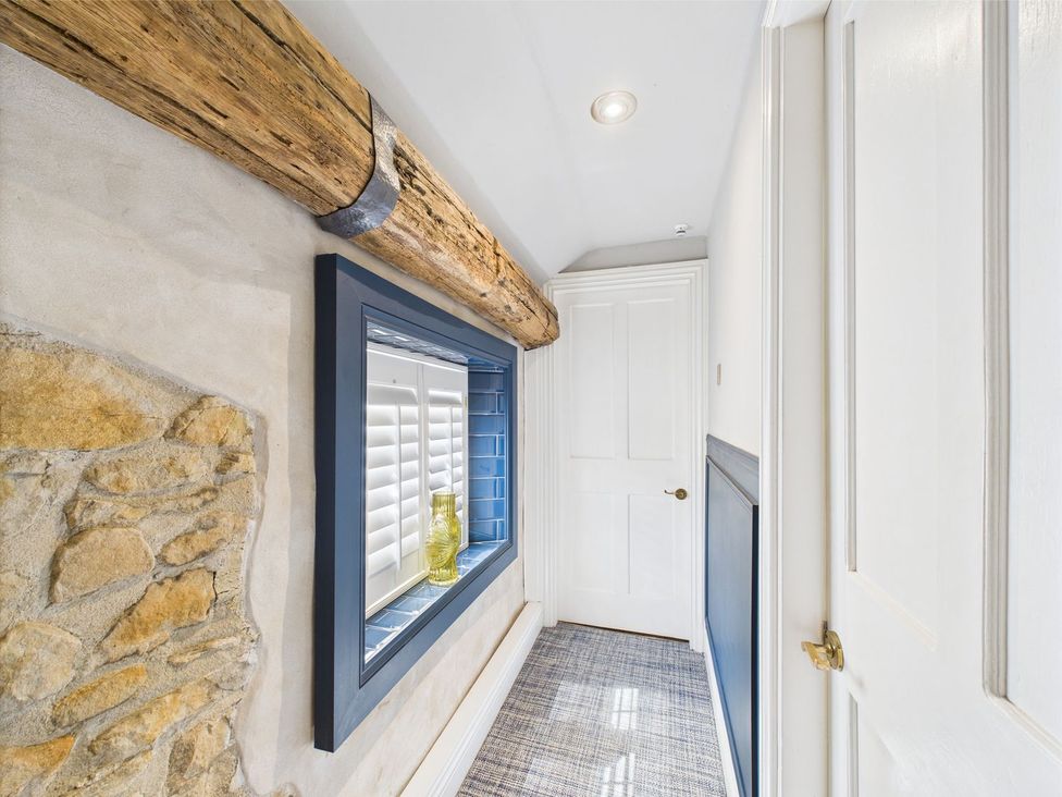 A hallway with a window and a door at The Smithy in Barnard Castle