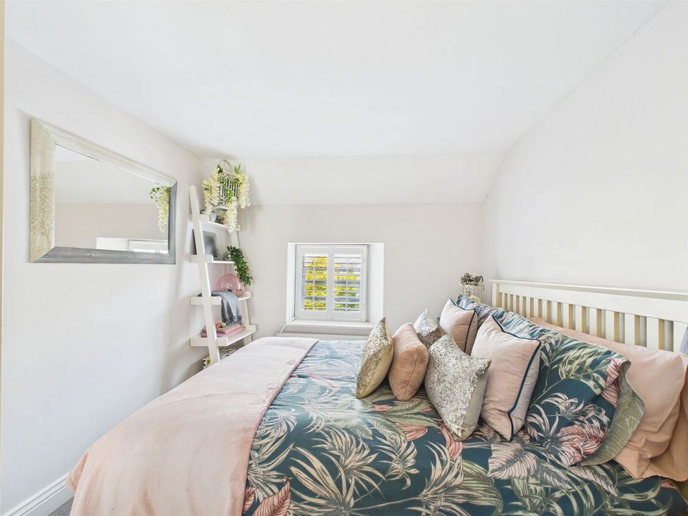 A bedroom with a bed and shelves at The Smithy in Barnard Castle
