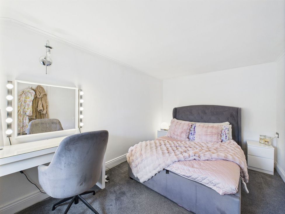 A bedroom with a bed and vanity setup at The Smithy in Barnard Castle