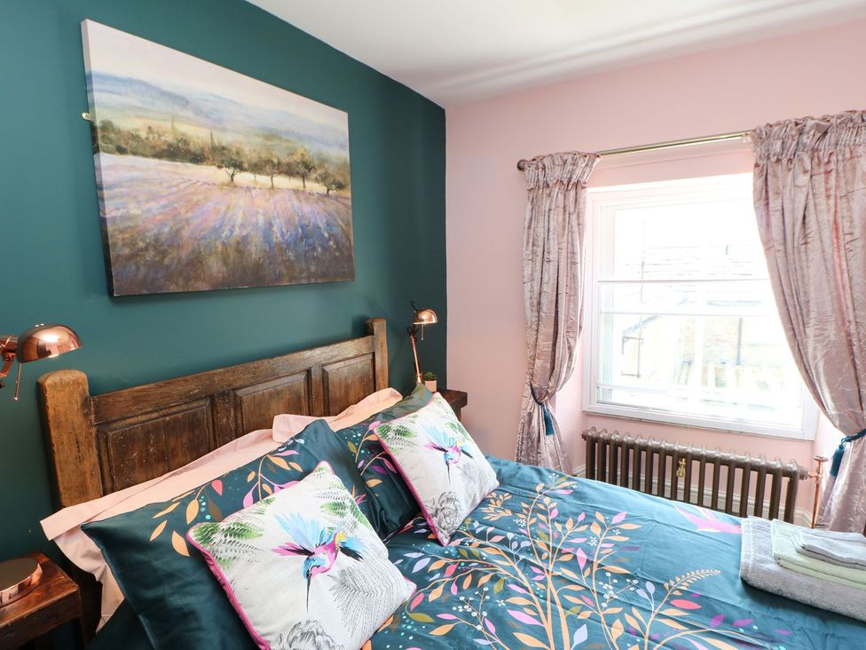 A bedroom with a bed and painting at The Smithy in Barnard Castle