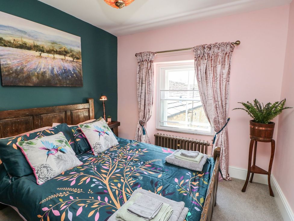 A bedroom with a bed and plant pot at The Smithy in Barnard Castle