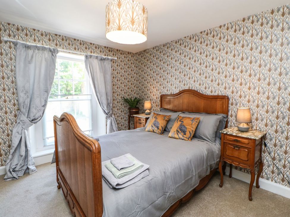 A bedroom with a bed and nightstands at The Smithy in Barnard Castle