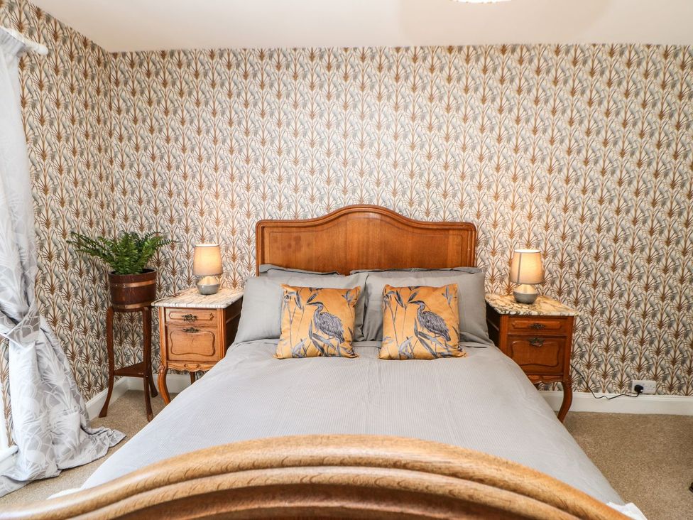 A bedroom with a bed and nightstands at The Smithy in Barnard Castle