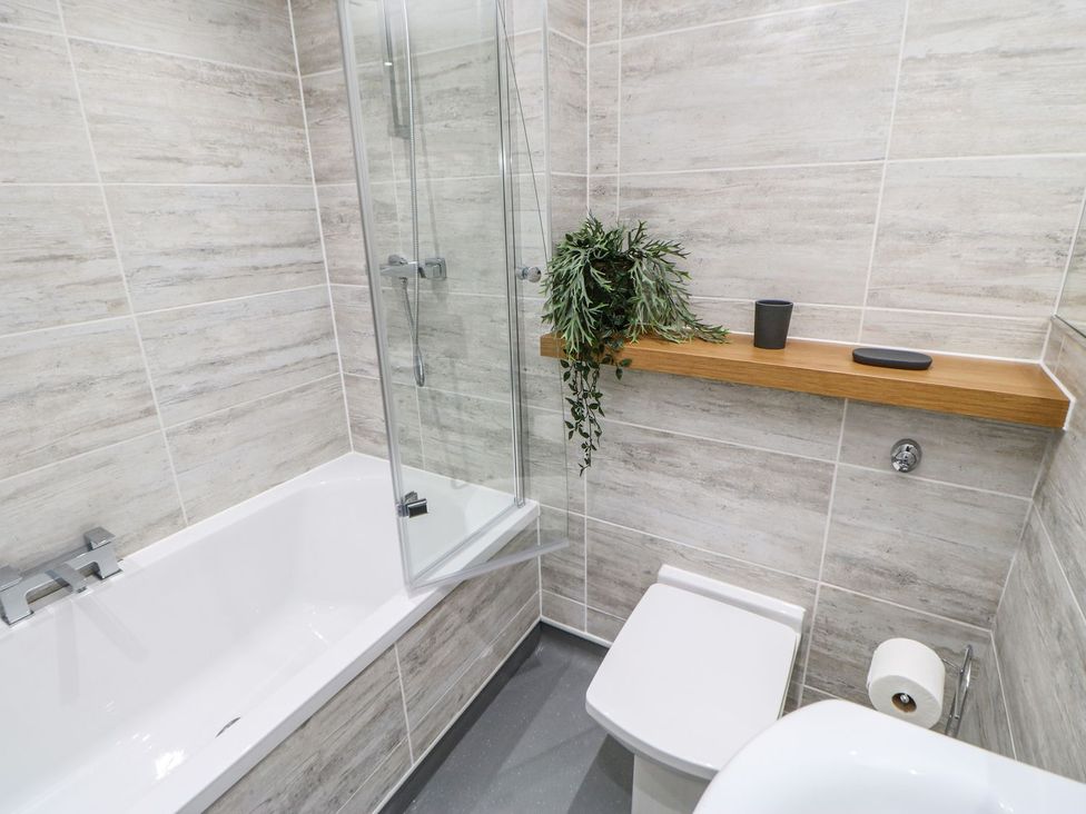 A bathroom with a bathtub and shower at The Smithy in Barnard Castle