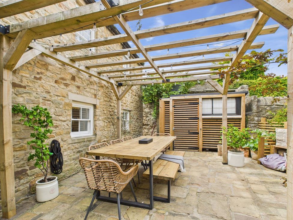 An outdoor dining area with table and chairs at The Smithy in Barnard Castle