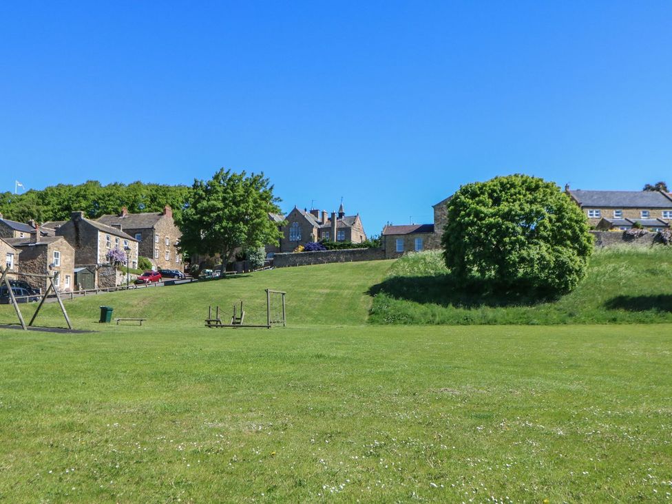 A playground area with houses in the background at The Smithy in Barnard Castle