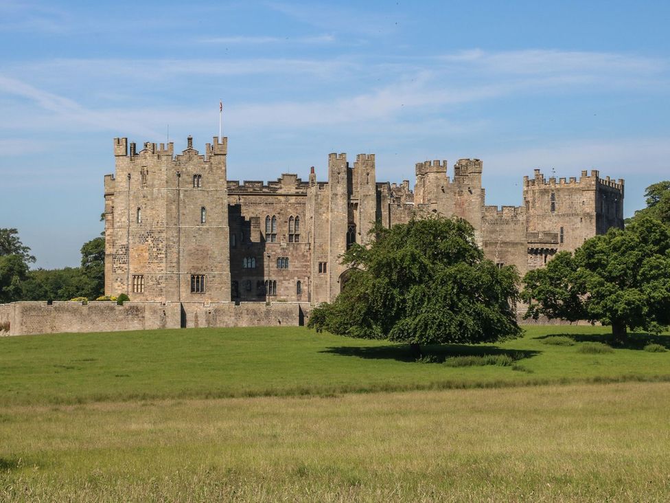 A castle surrounded by grass and trees at The Smithy in Barnard Castle