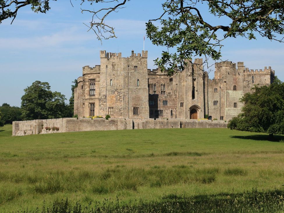 A castle surrounded by grass and trees at The Smithy in Barnard Castle