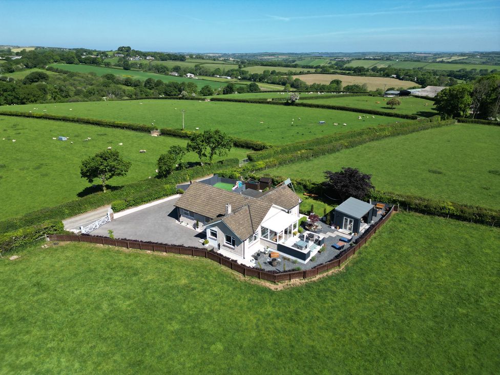 A house with a fenced garden in a rural area surrounded by green fields at Ashlea in Launceston