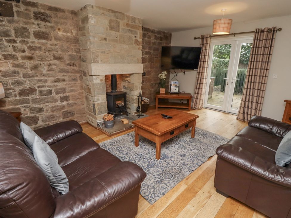 A living room with a fireplace and television at Crispin in Lucker