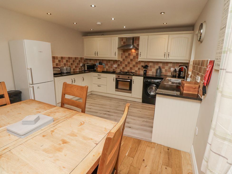 A kitchen with a dining table and appliances at Crispin in Lucker