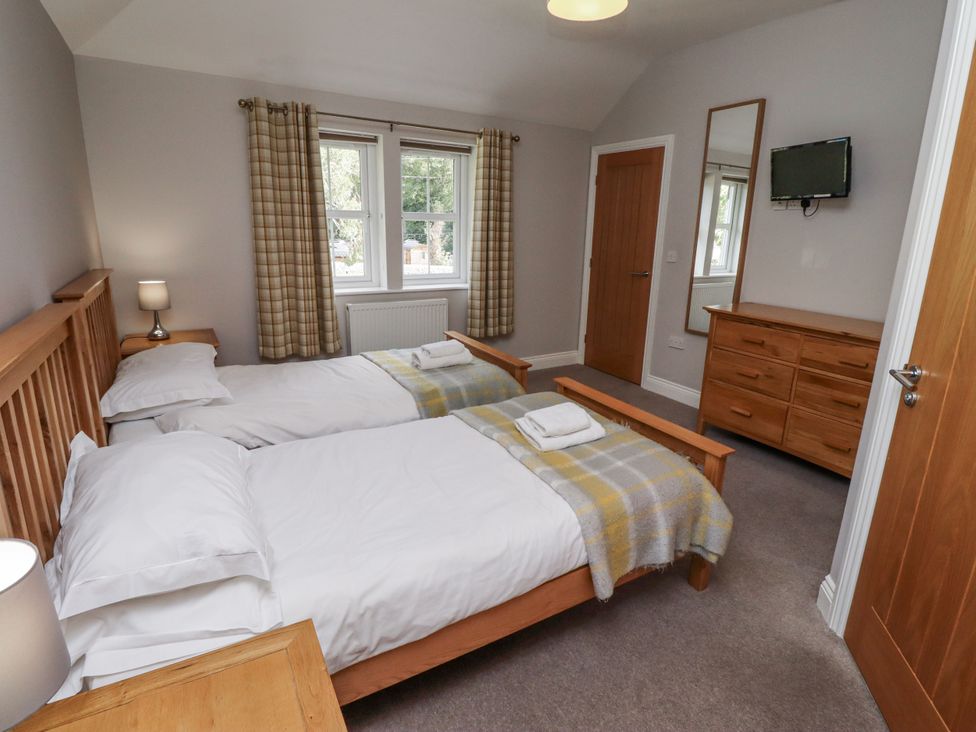 A bedroom with twin beds and a television at Crispin in Lucker