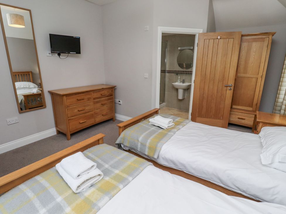 A bedroom with two beds and a dresser at Crispin in Lucker