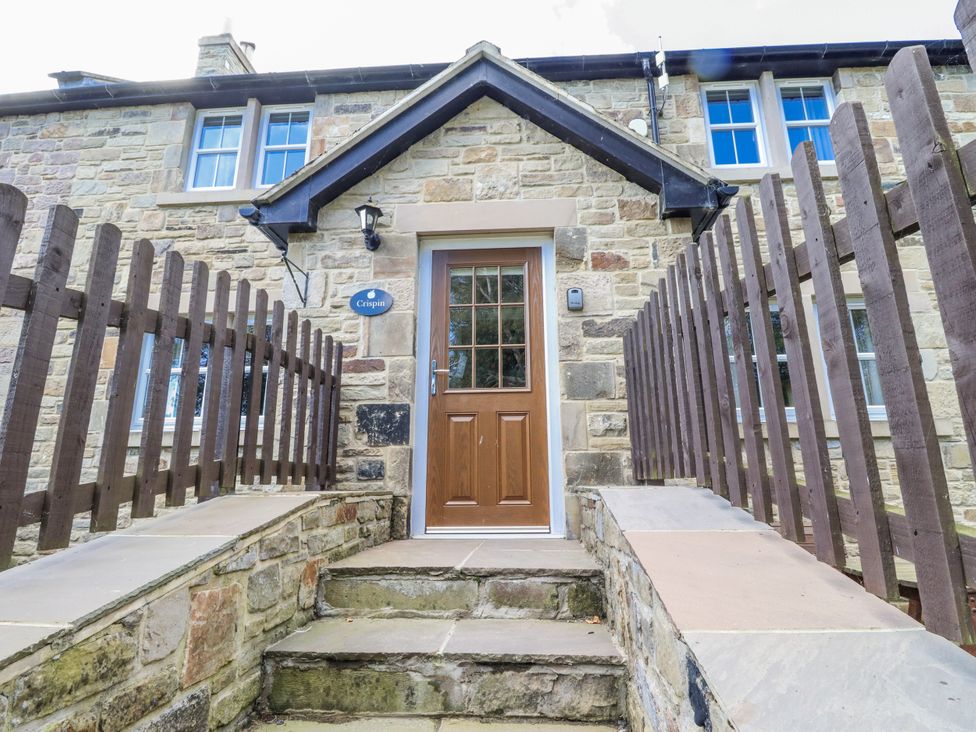 An entrance with steps leading to a wooden door at Crispin in Lucker