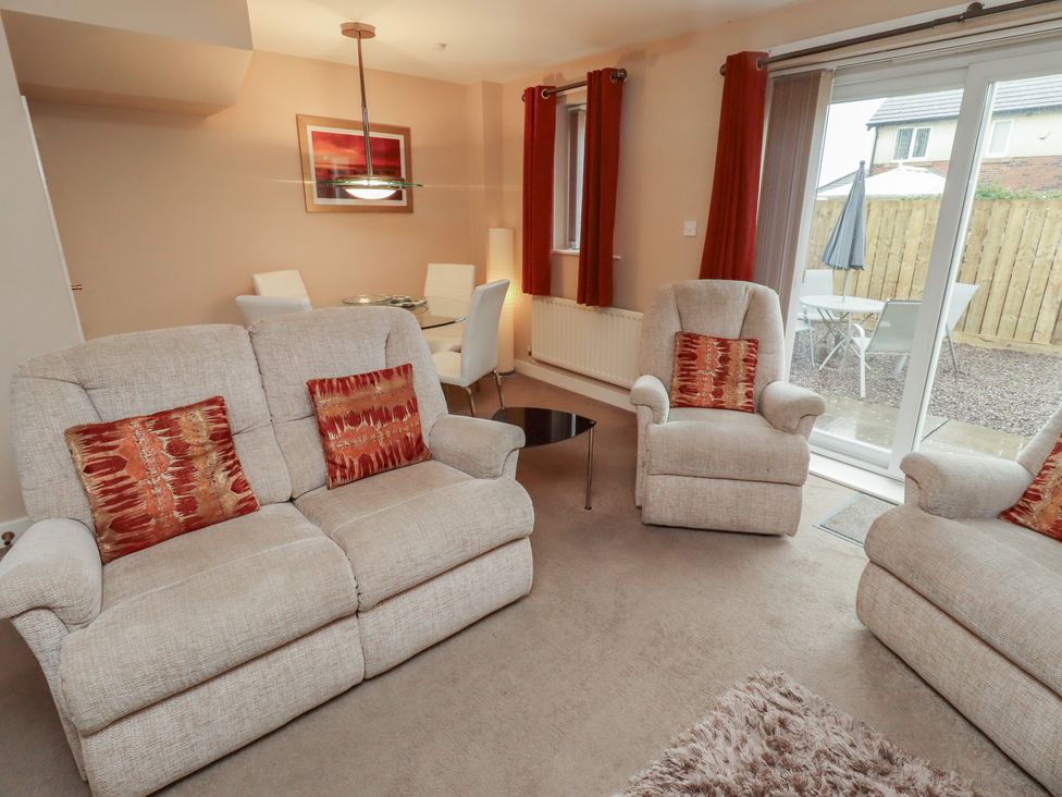 A living room with sofa and armchairs at Ahoy in Seahouses