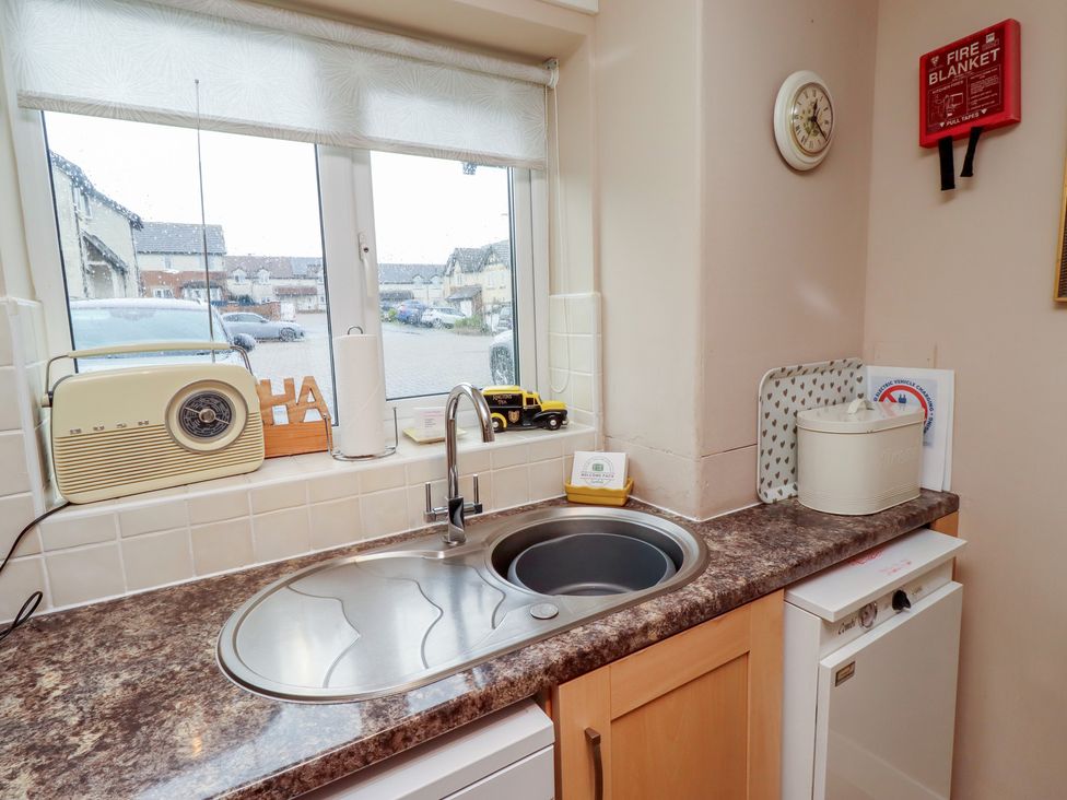 A kitchen with a sink and radio at Ahoy in Seahouses