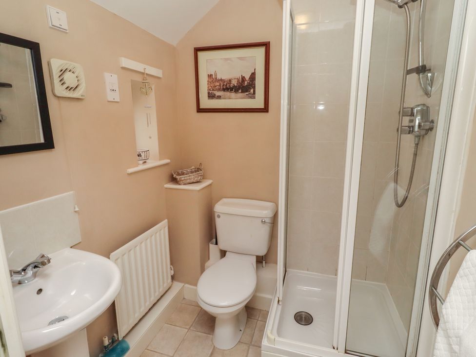 A bathroom with a shower, sink, and toilet at Ahoy in Seahouses