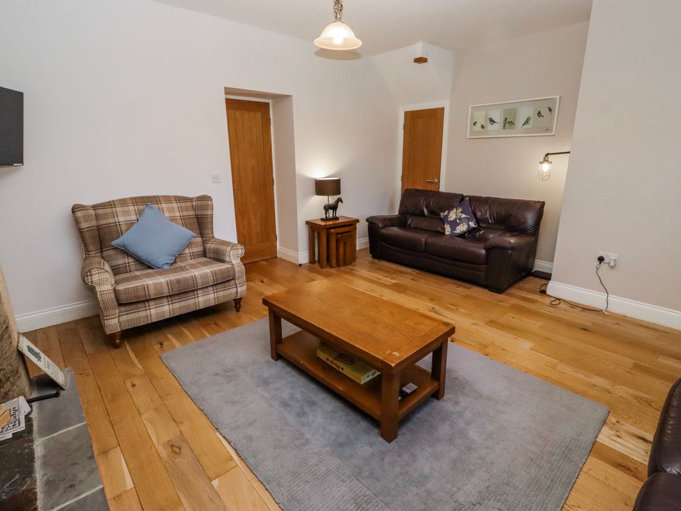A living room with a coffee table and seating at Bramley in Lucker