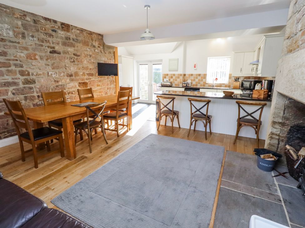 A kitchen with a dining table and chairs at Bramley in Lucker