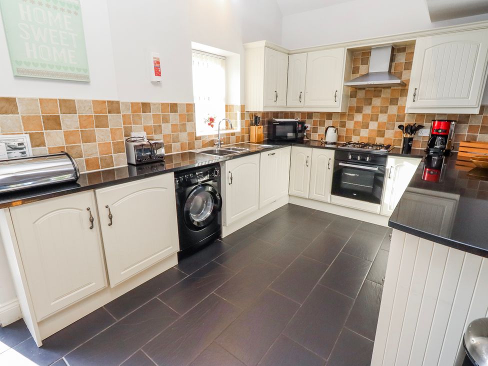 A kitchen with various appliances and cabinets at Bramley in Lucker