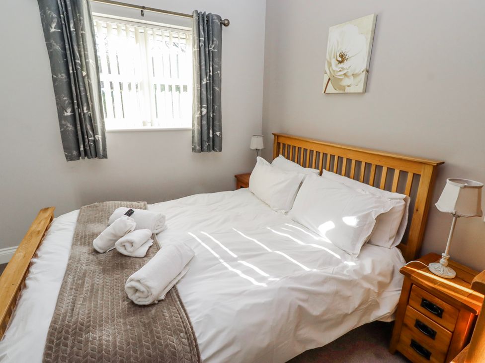 A bedroom with a bed and bedside table at Bramley in Lucker