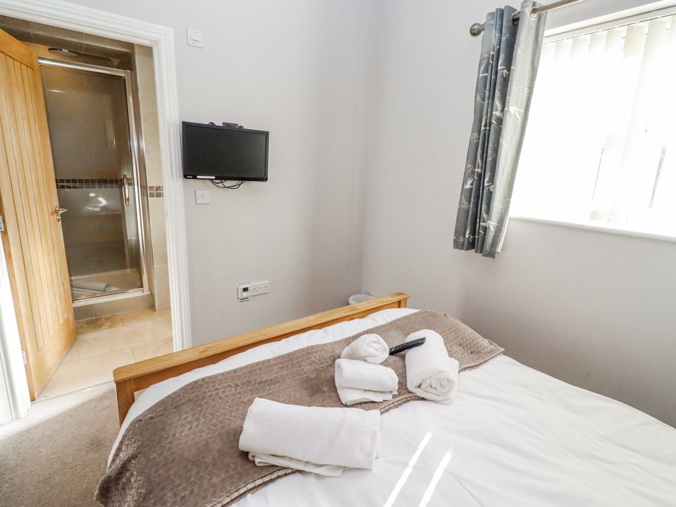 A bedroom with a bed and towels at Bramley in Lucker
