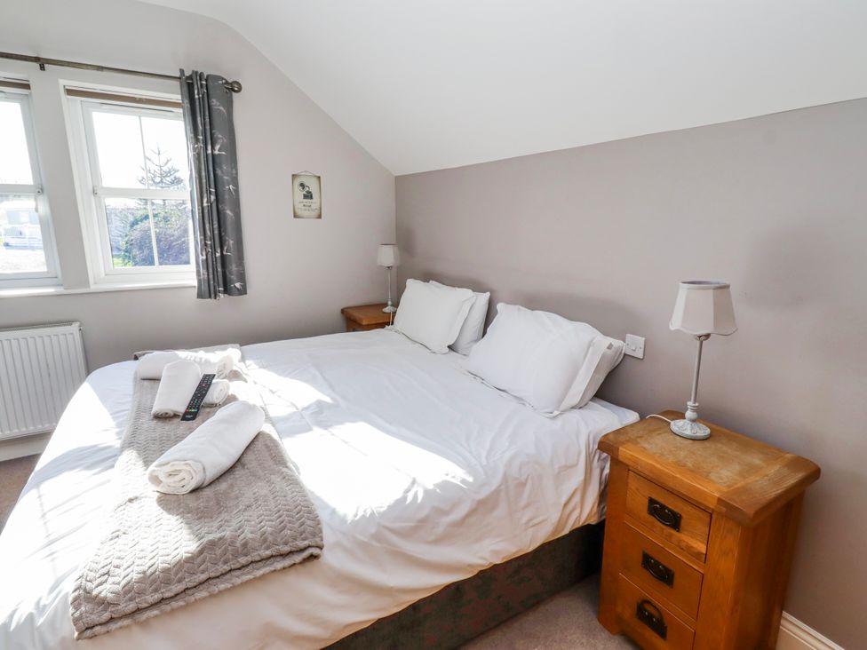 A bedroom with a bed and bedside table at Bramley in Lucker