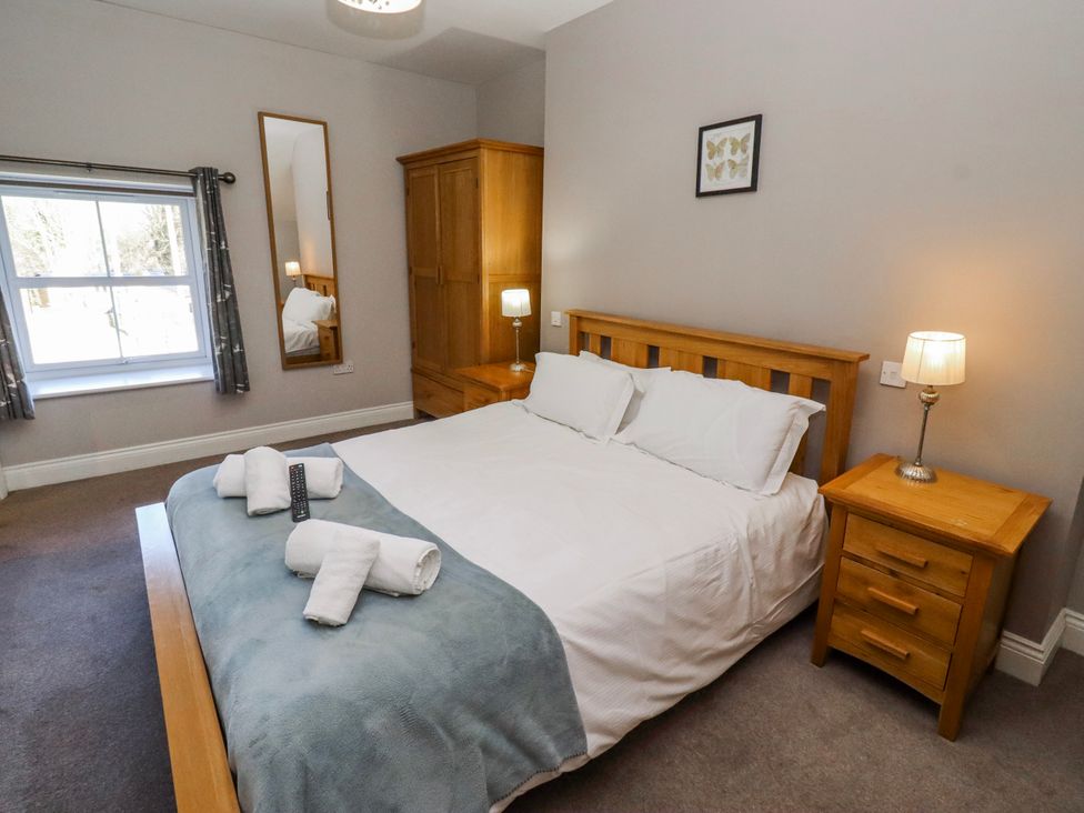 A bedroom with a bed and furniture at Bramley in Lucker