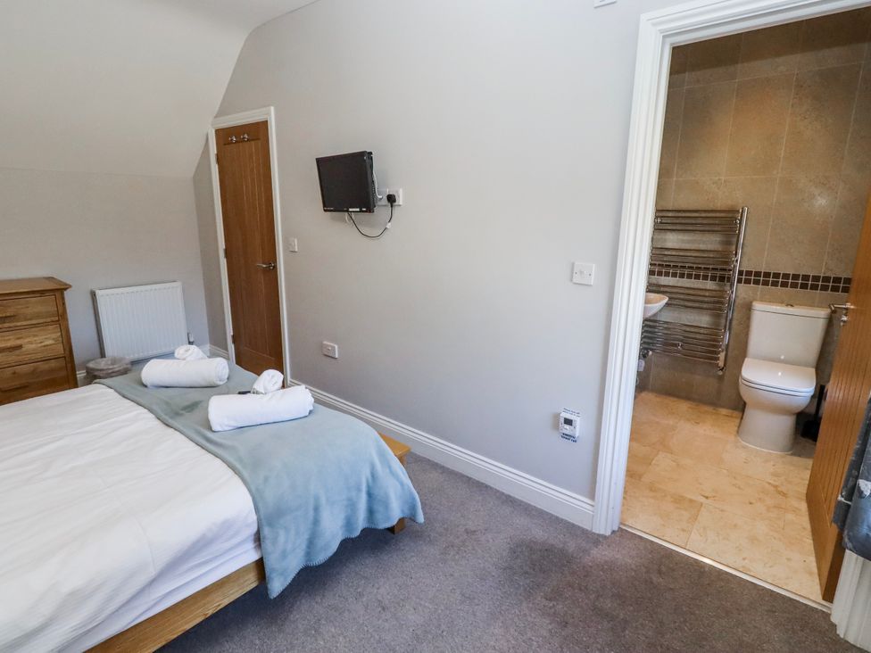 A bedroom with a bed and towels at Bramley in Lucker