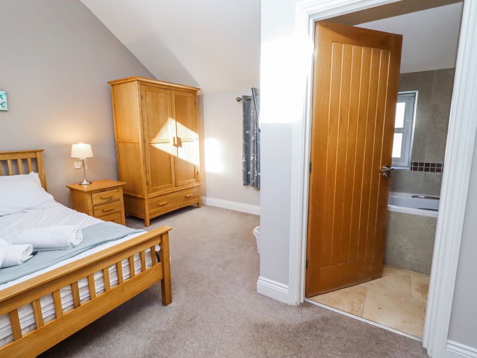 A bedroom with a bed and wardrobe at Bramley in Lucker