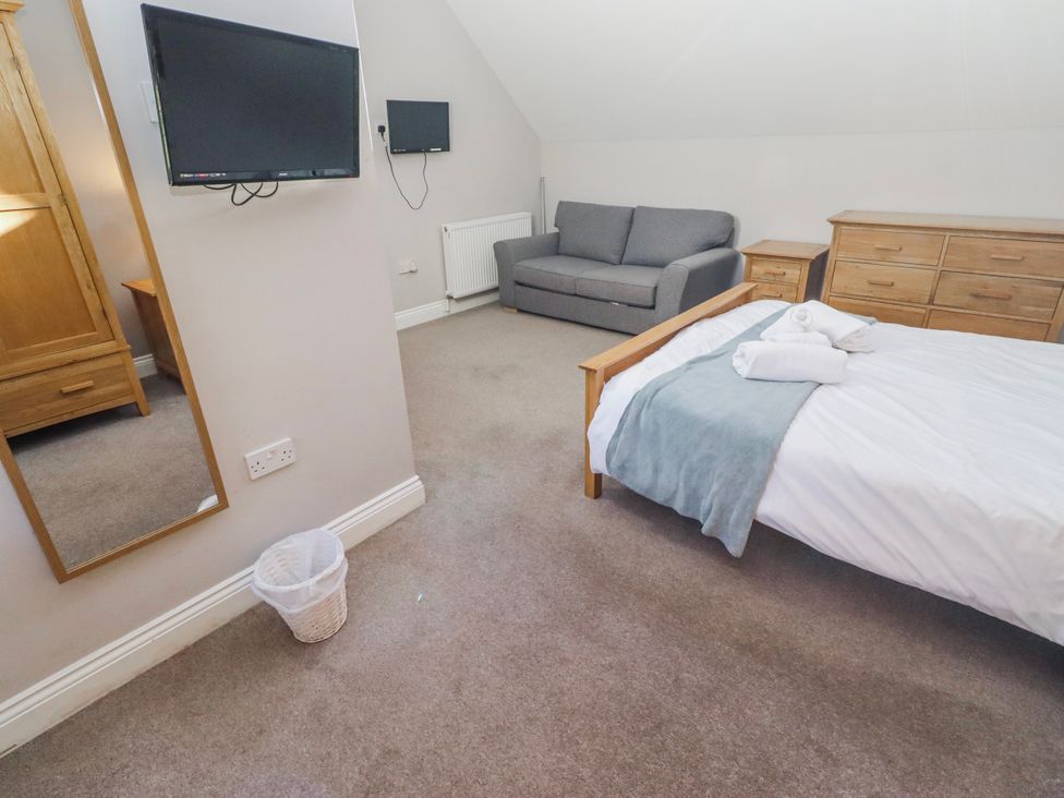 A bedroom with a bed and a couch at Bramley in Lucker