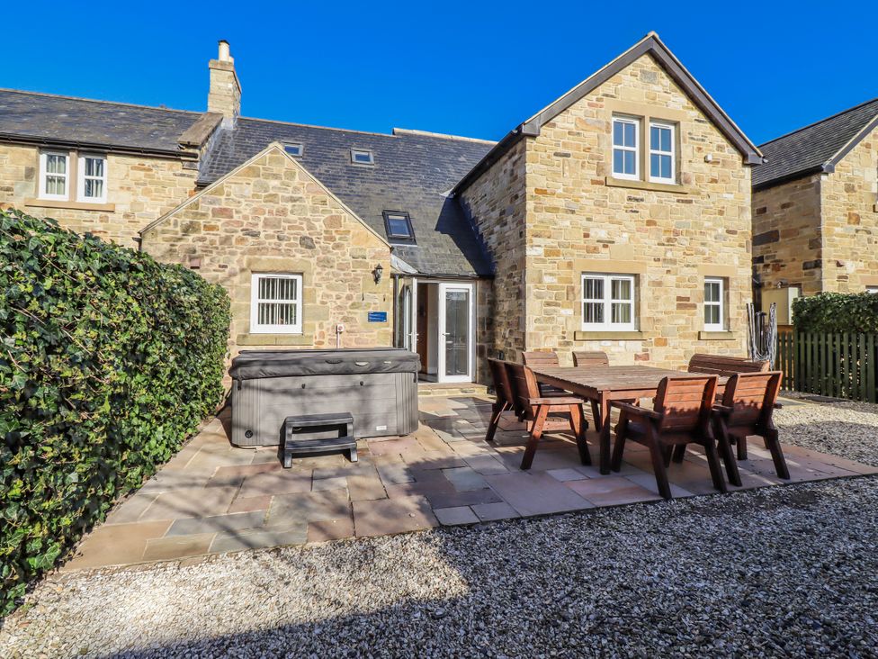 A house with a patio and hot tub at Bramley in Lucker