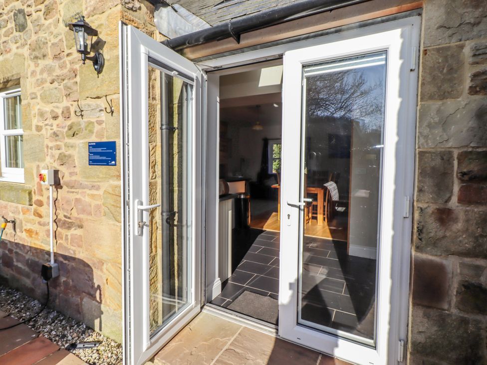 An entryway with double doors opening to a dining area at Bramley in Lucker