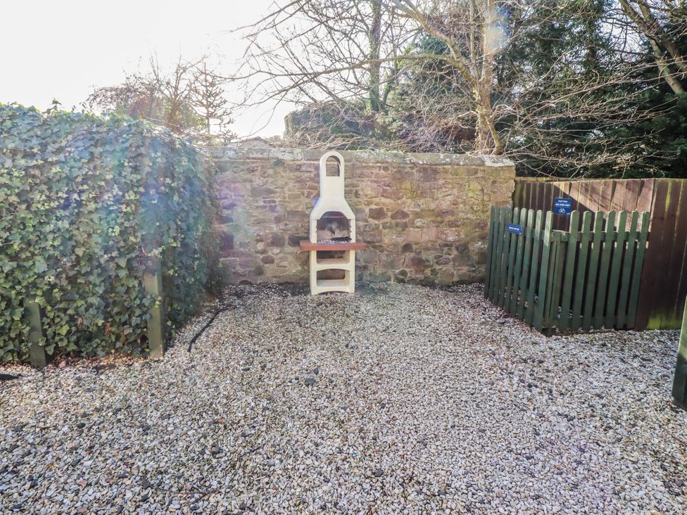 A garden with a barbecue and gravel at Bramley in Lucker