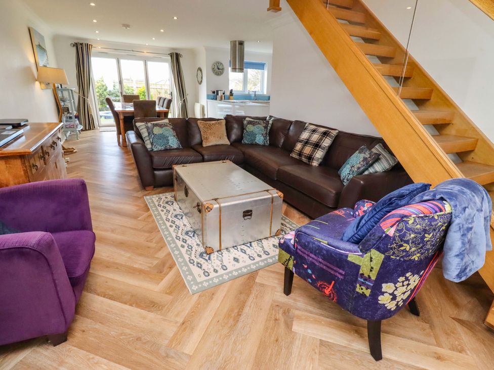A living room with a sofa and coffee table at Farne Cottage in Beadnell