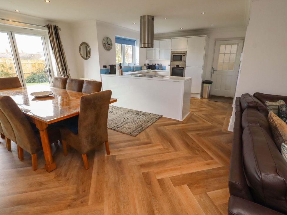 A dining area with a table and chairs at Farne Cottage Beadnell
