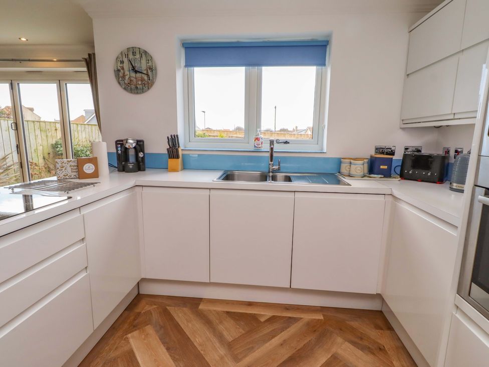 A kitchen with sink and coffee maker at Farne Cottage Beadnell
