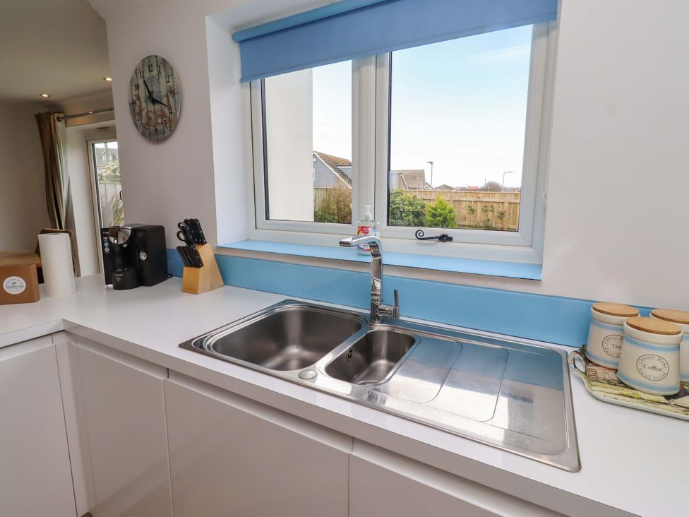 A kitchen with a sink and coffee machine at Farne Cottage in Beadnell