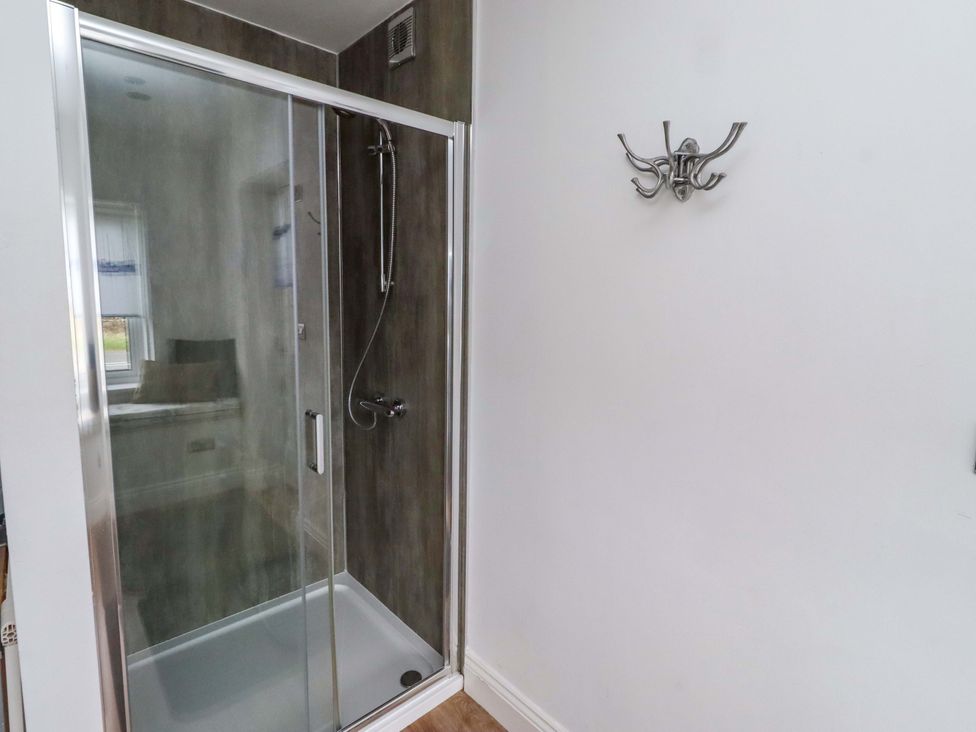 A shower enclosure in a bathroom at Farne Cottage in Beadnell