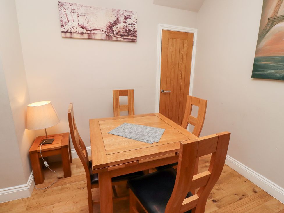 A dining room with a wooden table and chairs at Russet in Lucker
