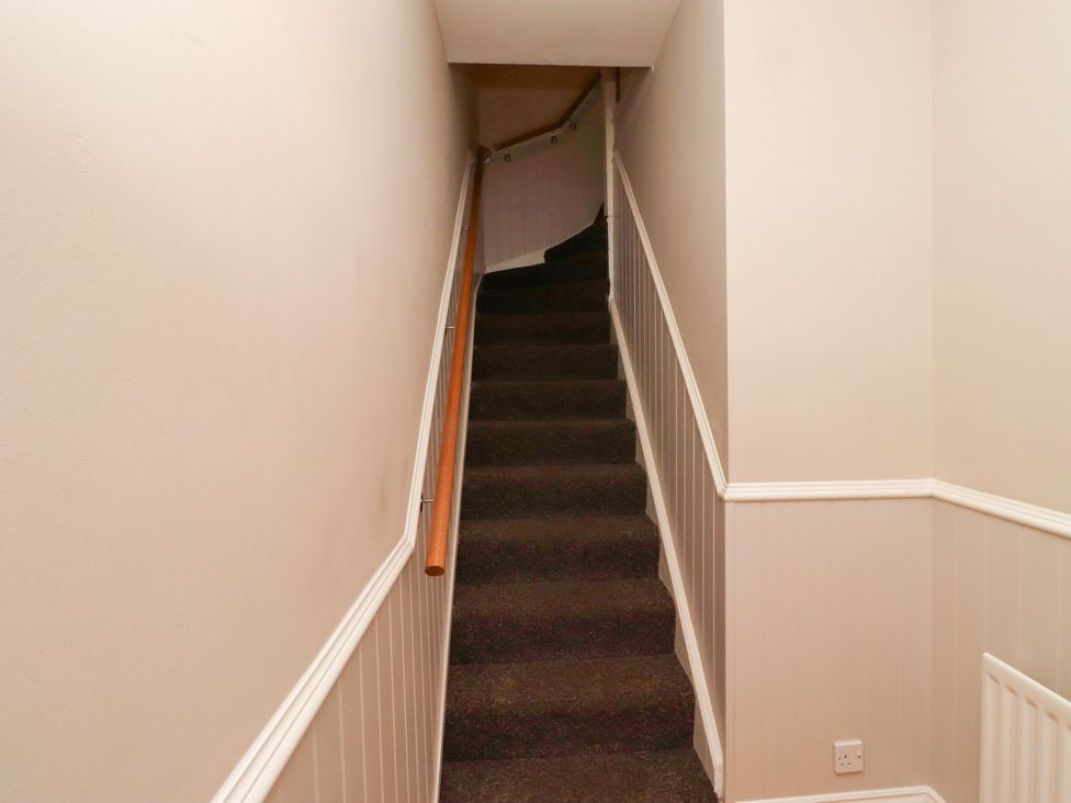 A staircase with carpet and a handrail at Russet in Lucker