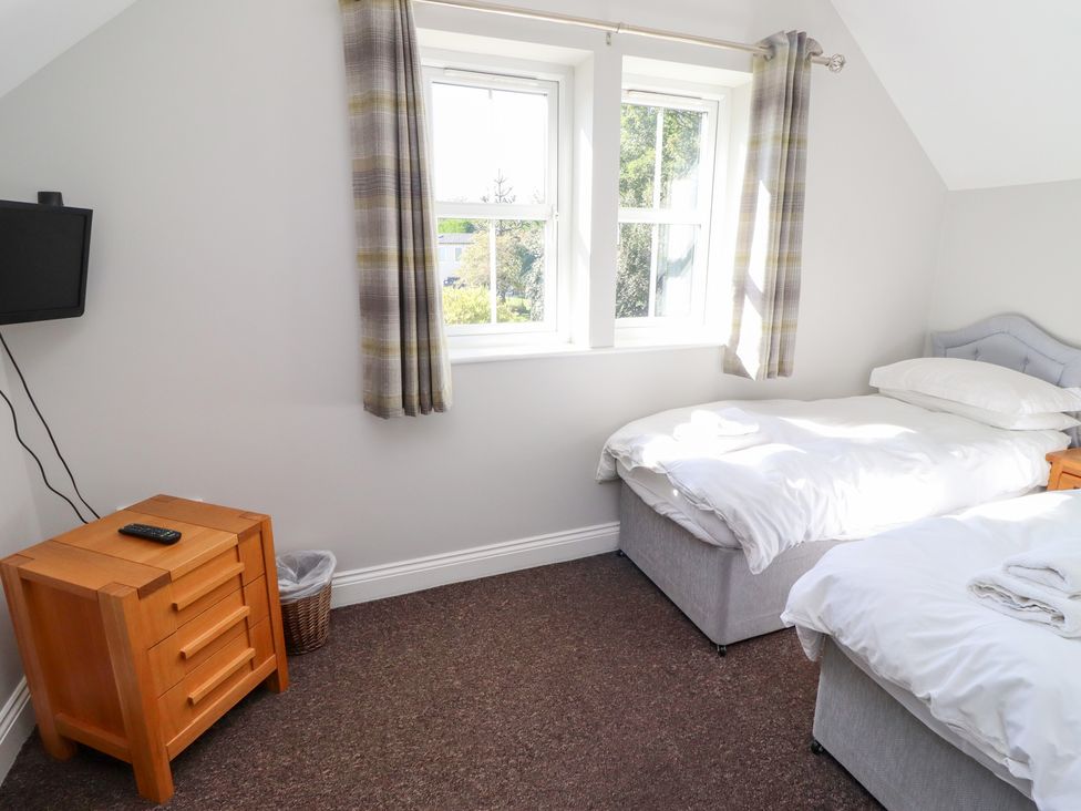 A bedroom with two beds and a television at Russet in Lucker