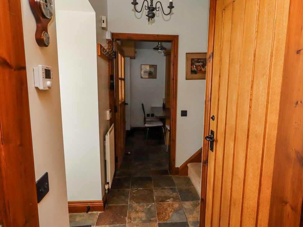 A hallway with tiles and a light fixture at No9 Budle Sands in Bamburgh