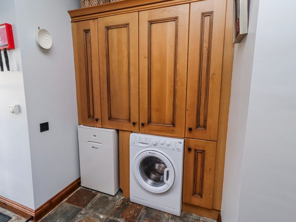 A laundry room with cabinets and appliances at No9 Budle Sands in Bamburgh