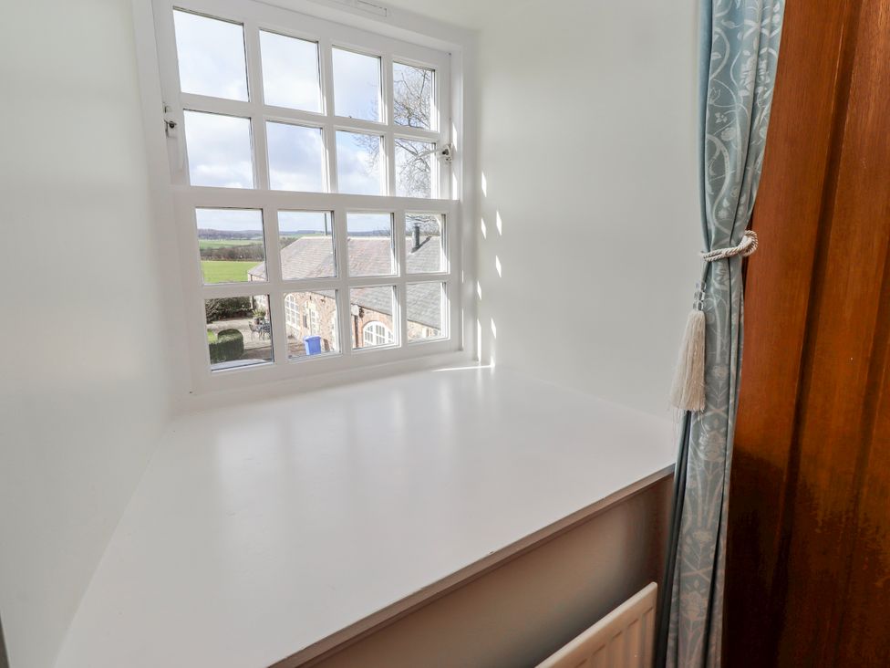 A window with a sill and curtain at No9 Budle Sands in Bamburgh