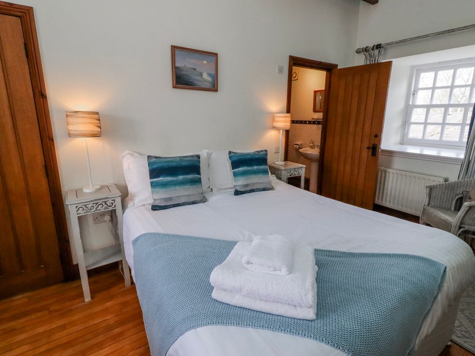 A bedroom with a bed and bedside table at No9 Budle Sands in Bamburgh