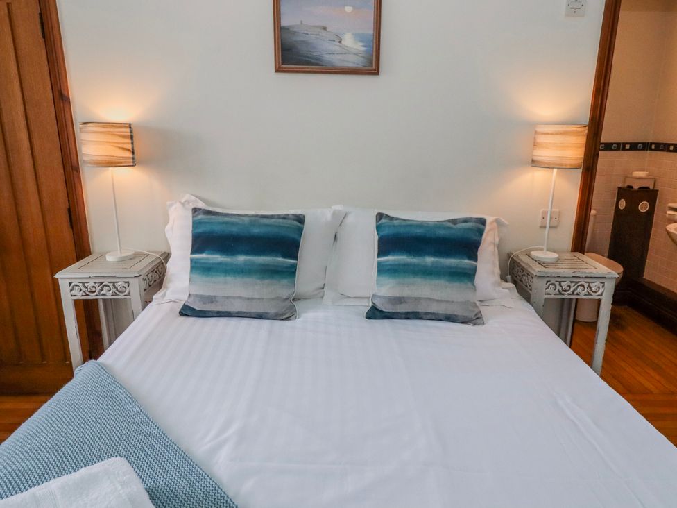 A bedroom with a bed and side tables at No9 Budle Sands in Bamburgh