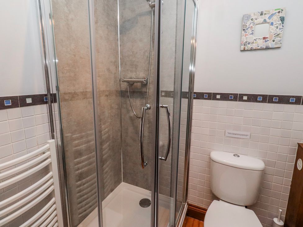 A bathroom with a shower and toilet at No9 Budle Sands in Bamburgh