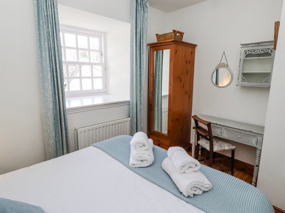 A bedroom with a bed and a desk at No9 Budle Sands in Bamburgh
