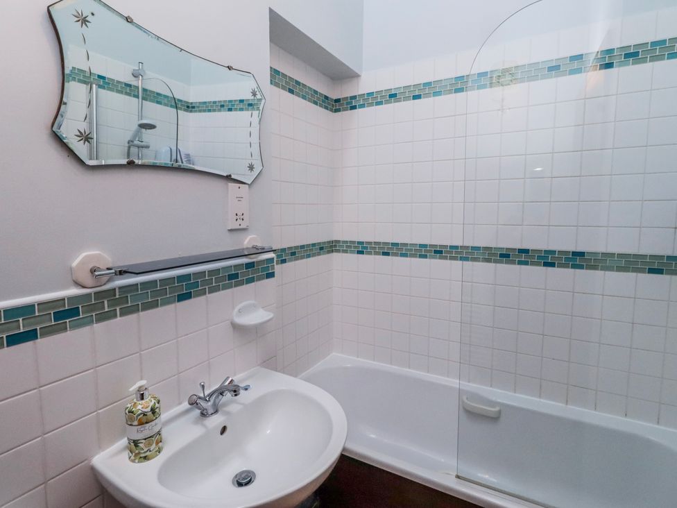 A bathroom with a sink and bathtub at No9 Budle Sands in Bamburgh